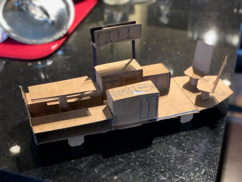 Cardboard mockups of furniture in the van