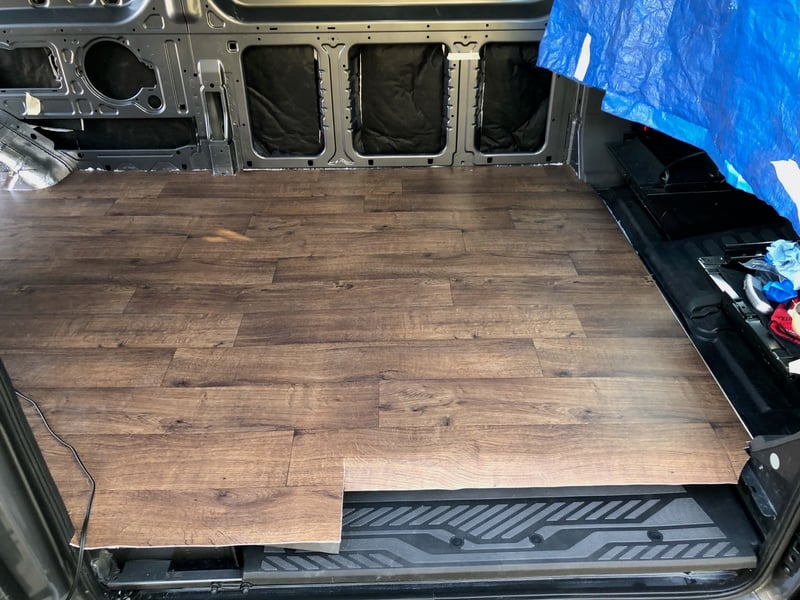 Wood-effect vinyl flooring laid over the plywood subfloor