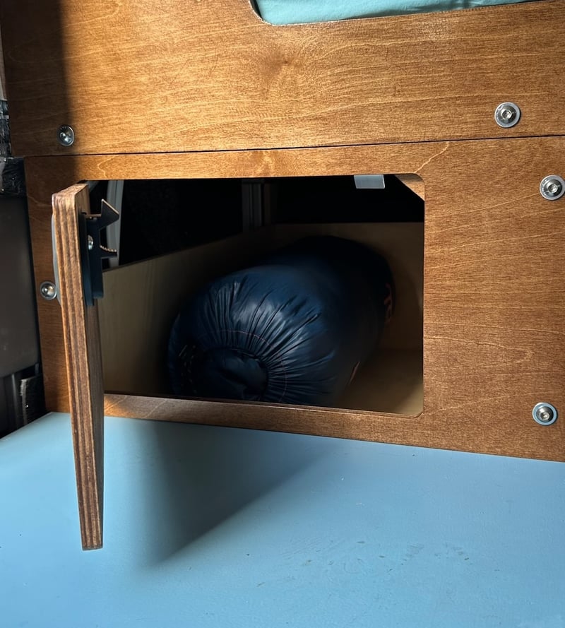 The beer cubby under the passenger-side bed foot